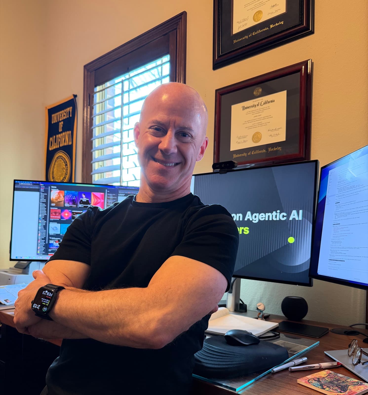 James Gray in his office with Berkeley diplomas and AI course materials